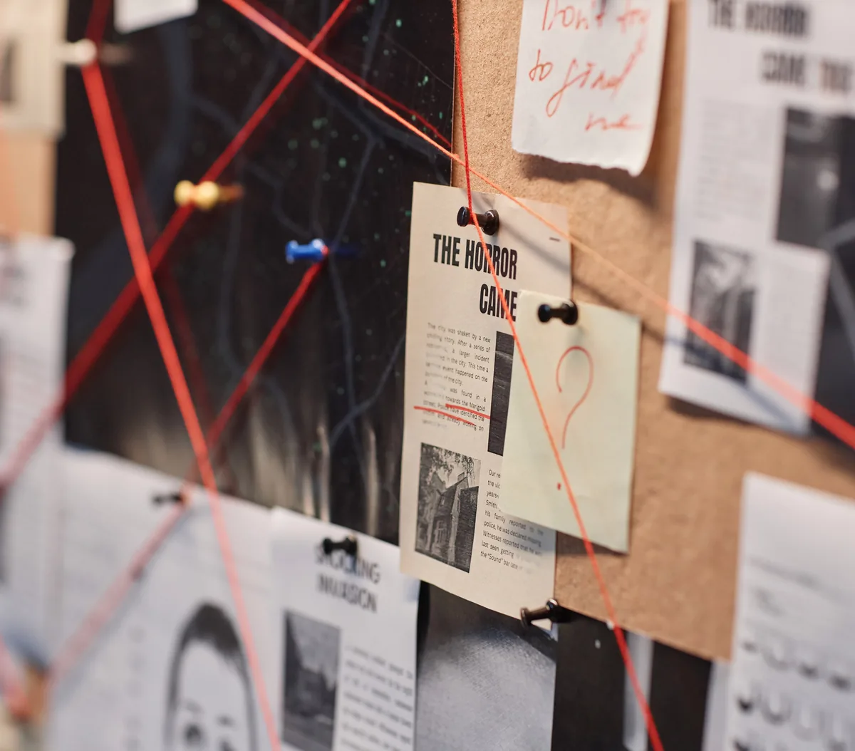 A corkboard of pinned clippings joined by red thread, the detective-board arrangement the Redstring corkboard view is named after