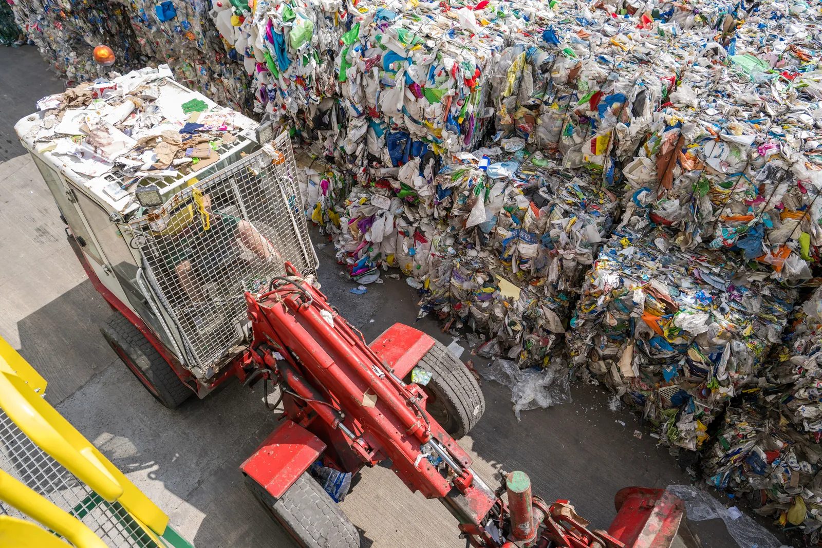 Baled materials moving through a recycling facility